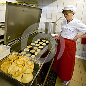 Female cook in kitchen