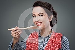 Female cook tasting a recipe