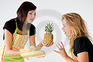 Female cooks and pineapple