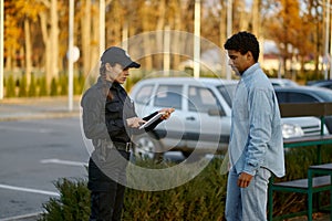 Female cop checking male passerby ID document