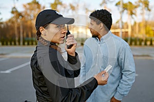 Female cop checking male passerby ID document