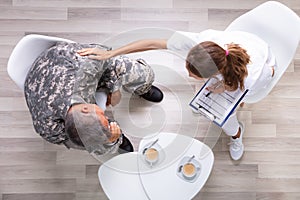 Female Councilor Consoling Soldier At Her Clinic