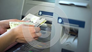 Female counting Russian rubles withdrawn from ATM, 24h service, easy banking