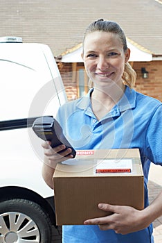 Female Courier Delivering Package To Domestic House