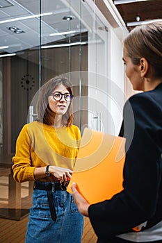 Female coworker conversation indoor contemporary business center