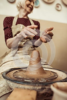 Female craftsman working on potters wheel