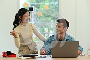 Female creative designer and male project manager working on new startup project in modern office