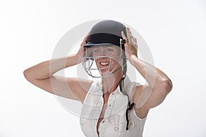 Female cricketer putting on safety helmet