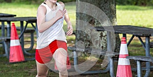 Female cross country runner finishing a 5K in a park