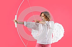 Female cupid shooting love arrow with bow. Valentines day celebration. Angel girl in white wings.