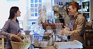 Female customer buying loaf of bread