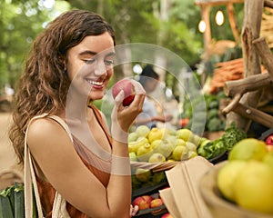 Female Customer At Market Stall Choosing Fresh Fruit And Vegetables