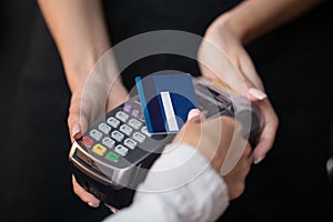Female customer pay hold credit card use contactless nfc technology