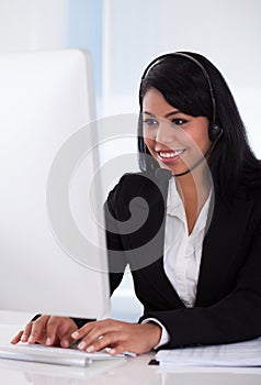 Female customer representative using computer