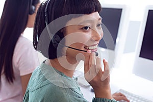 Female customer service executive working on computer at desk