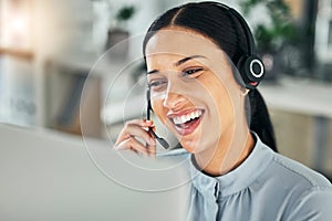 Female customer service representative using headset and consulting clients online. Call center concept. Smiling young