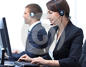 Female Customer Services Agent With Headset Working In A Call Center
