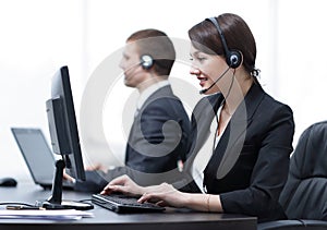 Female Customer Services Agent With Headset Working In A Call Center