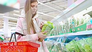 female customer sniffing fresh greenery in supermarket, choosing only freshest and highest quality