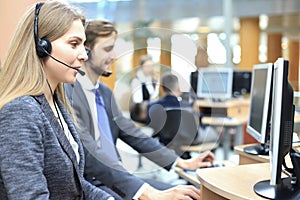 Female customer support operator with headset and smiling