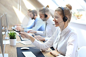 Female customer support operator with headset and smiling