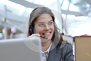 Female customer support operator with headset and smiling