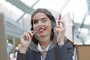 Female customer support operator with headset and smiling