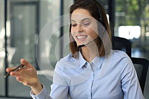 Female customer support operator with headset and smiling