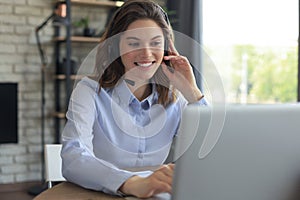 Female customer support operator with headset and smiling