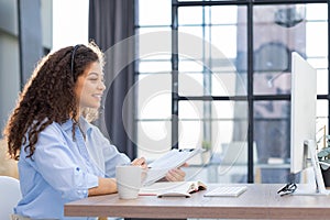 Female customer support operator with headset and smiling.