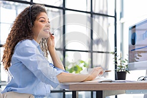 Female customer support operator with headset and smiling.