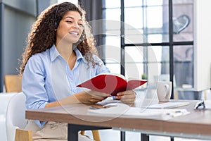 Female customer support operator with headset and smiling.