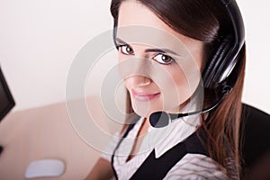 Female customer support operator with headset and smiling