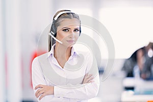 Female customer support operator with headset and smiling