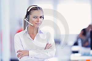 Female customer support operator with headset and smiling