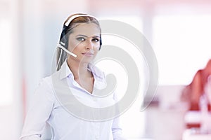 Female customer support operator with headset and smiling