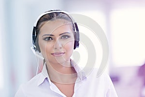 Female customer support operator with headset and smiling