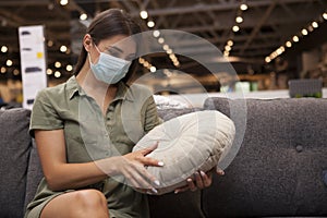 Female customer wearing face mask at furniture store