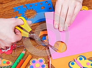 Female that cut paper shapes for children