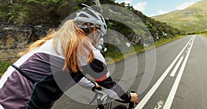 Female cyclist cycling on a countryside road 4k