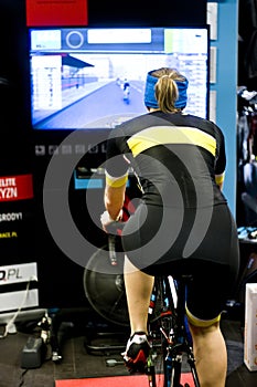 Female cyclist training indoor photo