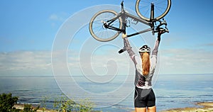Female cyclist holding bicycle in countryside road 4k