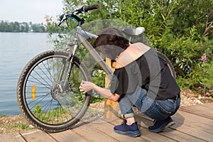 A female cyclist twists the cap on the tire