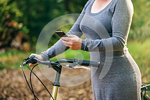 Female cyclist using mobile phone application