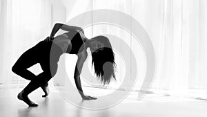 Female Dance Artist Training And Posing In Ballet Studio