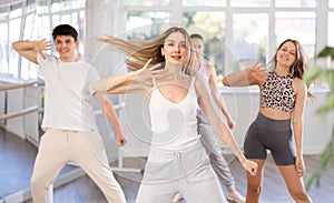 Female dancer in activewear rehearsing street dance in studio