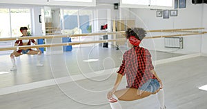 Female dancer practices her moves in studio photo