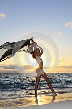 Female dancer standing by the ocean