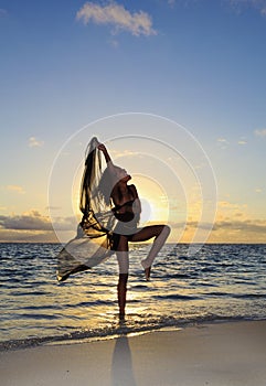 Female dancer standing in the ocean