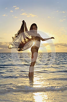 Female dancer standing in the ocean